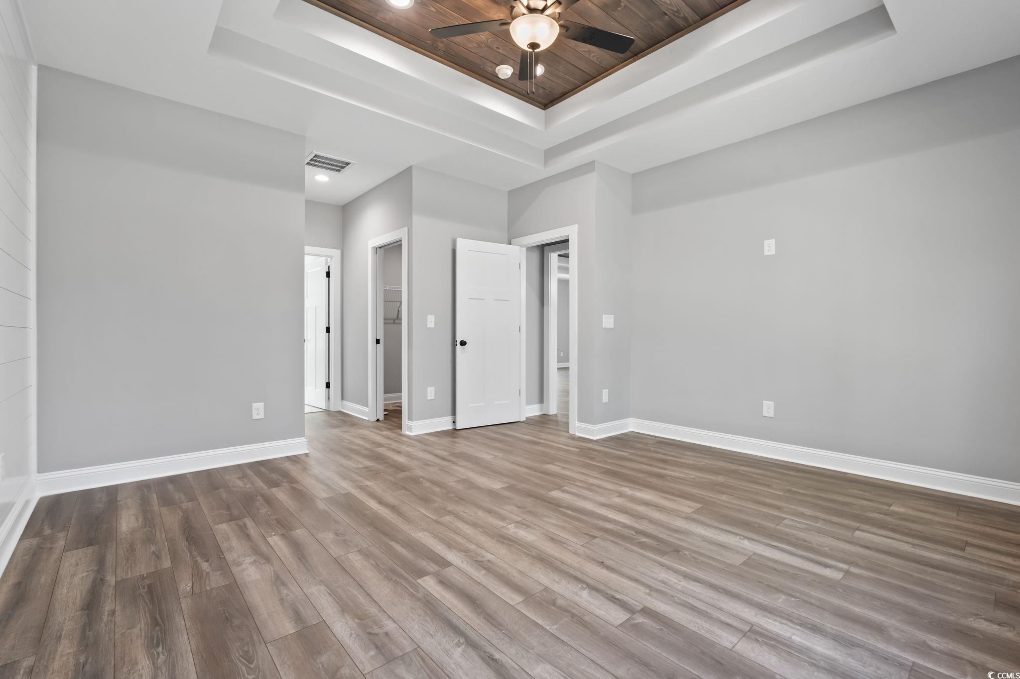 2122 Highway 9 Business Loris, SC 29569 - Photo 18 of 32 Unfurnished bedroom with a tray ceiling, wood finished floors, ceiling fan, recessed lighting, and wooden ceiling