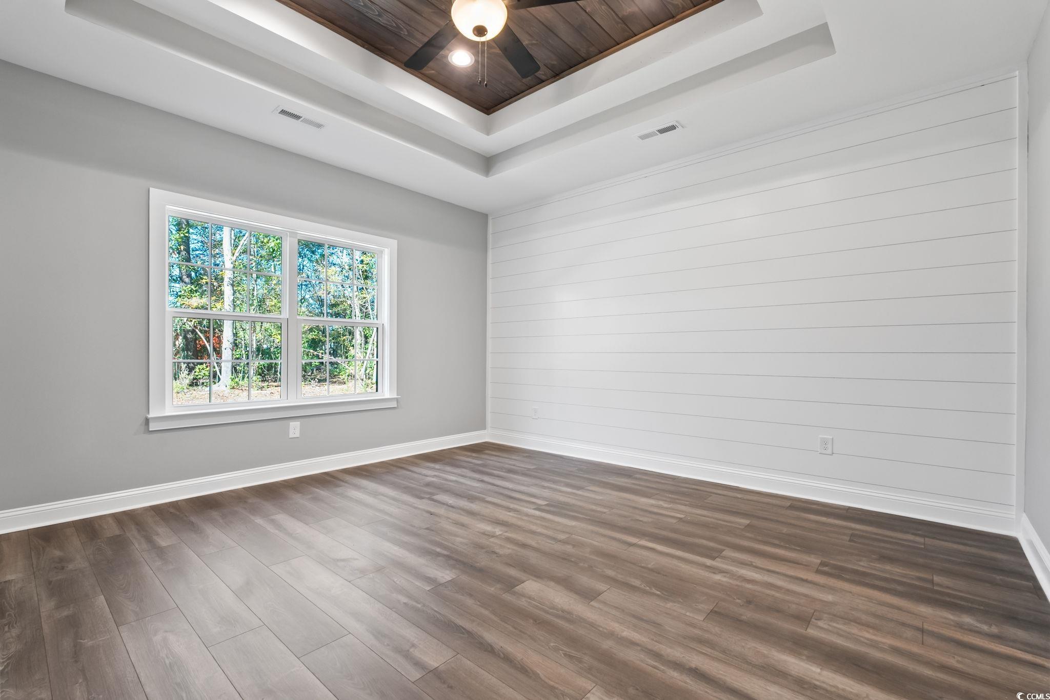 2122 Highway 9 Business Loris, SC 29569 - Photo 20 of 32 Unfurnished room featuring dark wood-style floors, wooden walls, a tray ceiling, and wooden ceiling