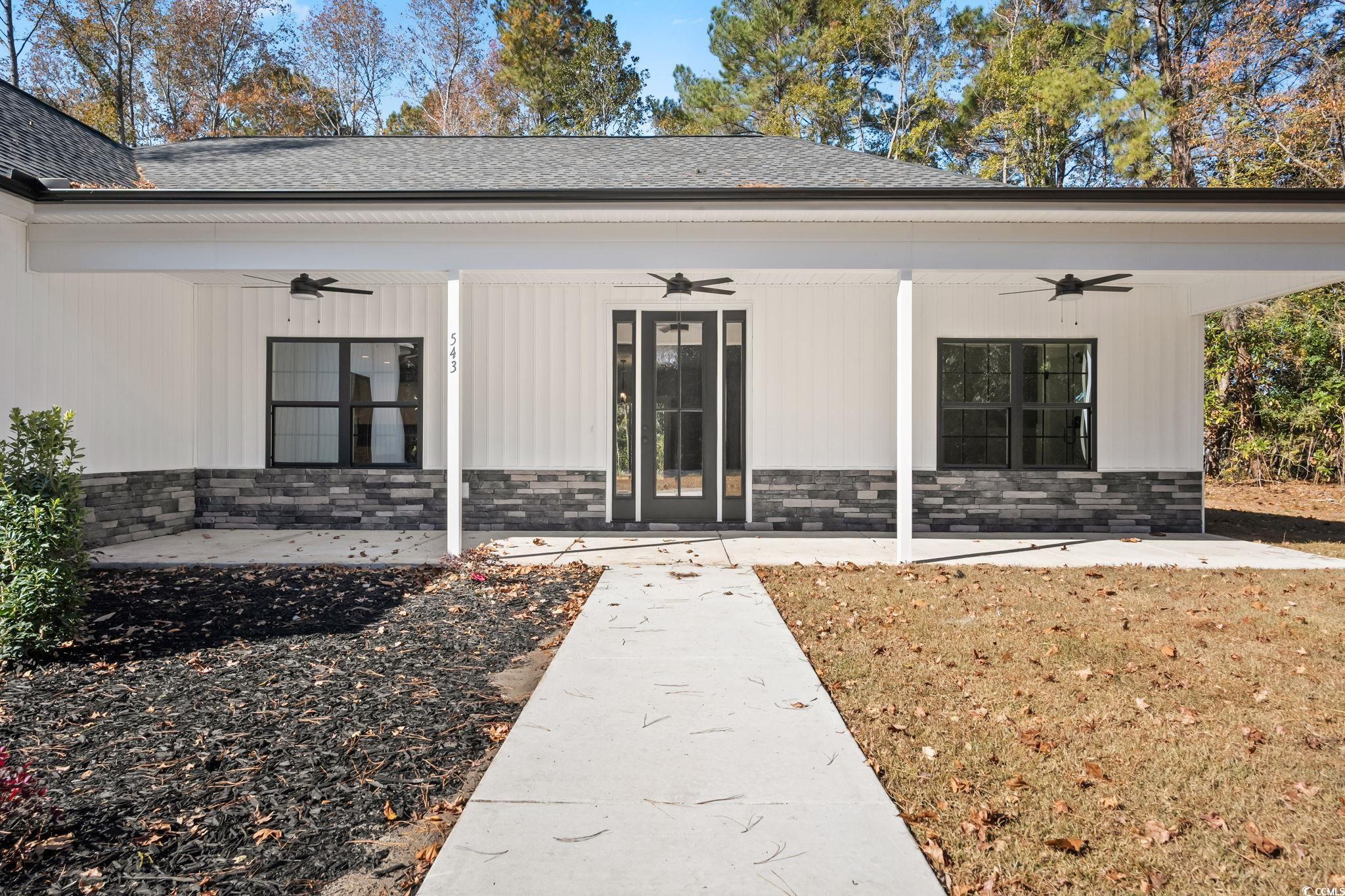 2122 Highway 9 Business Loris, SC 29569 - Photo 2 of 32 Doorway to property with ceiling fan, a porch, and stone siding