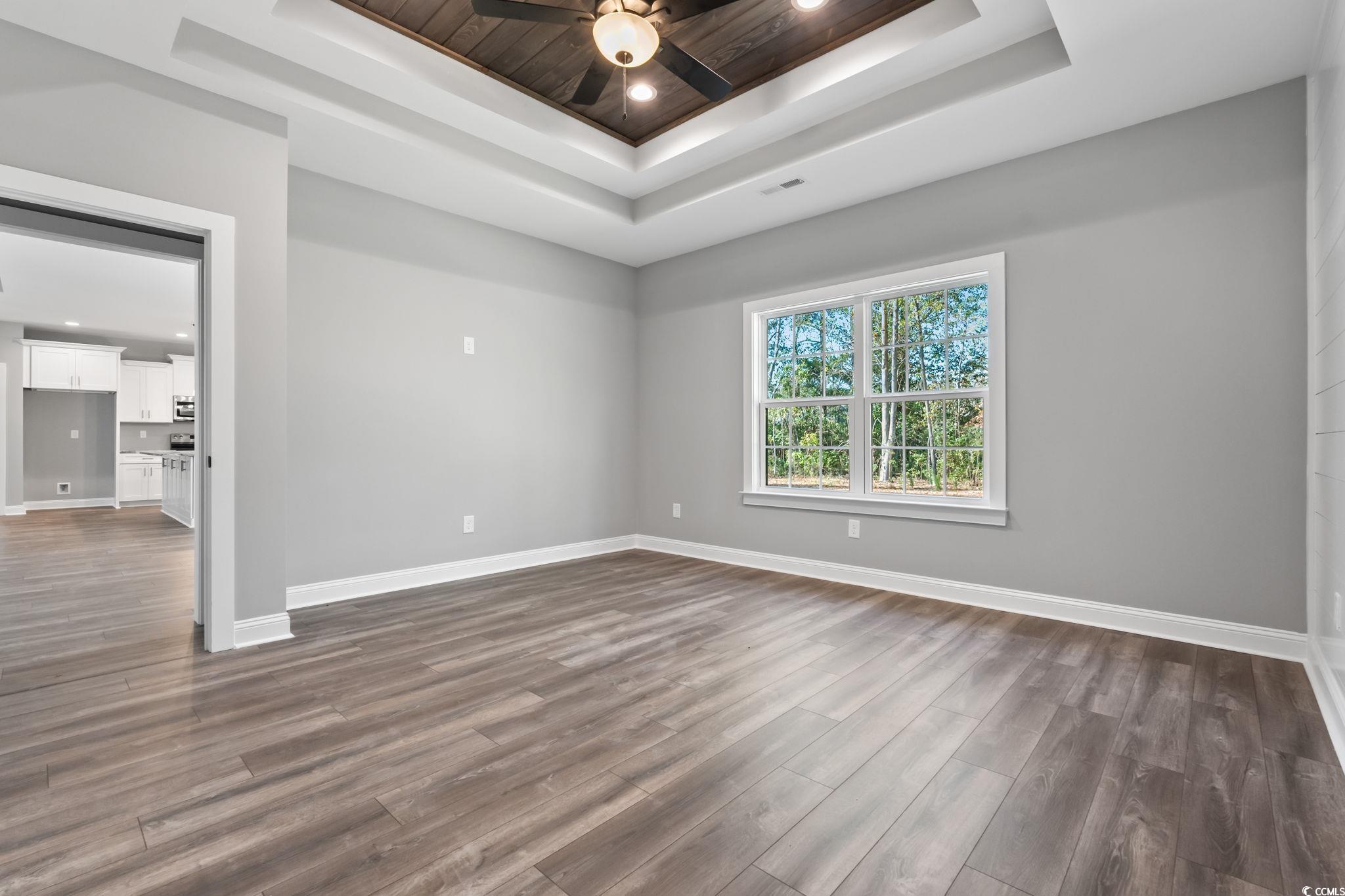 2122 Highway 9 Business Loris, SC 29569 - Photo 21 of 32 Empty room featuring dark wood-style flooring, recessed lighting, a tray ceiling, and ceiling fan