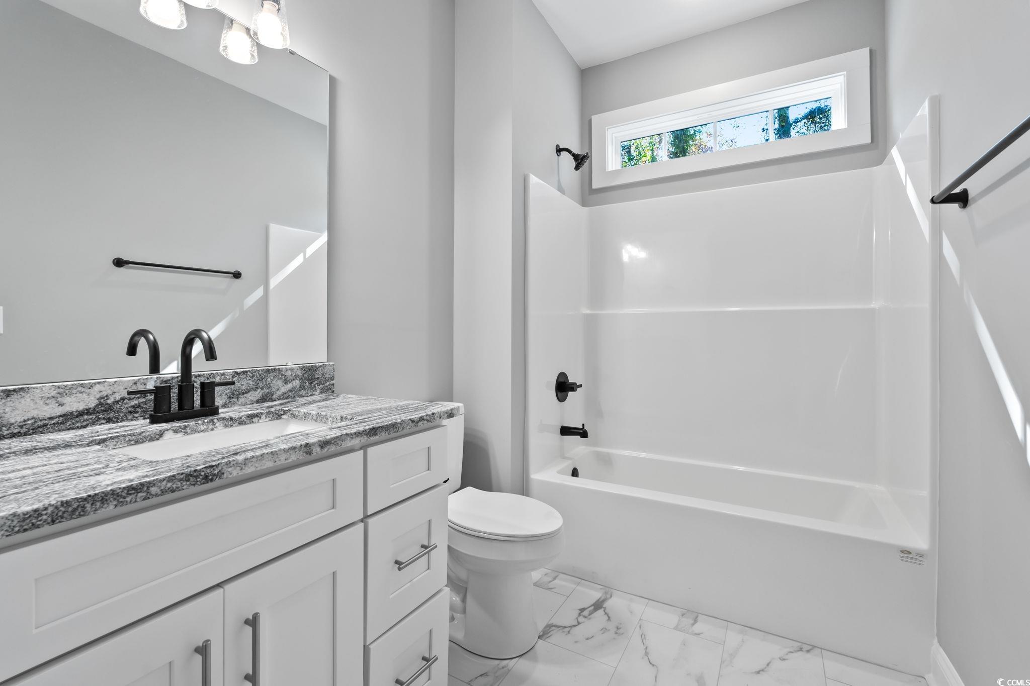 2122 Highway 9 Business Loris, SC 29569 - Photo 27 of 32 Full bathroom featuring tub / shower combination, vanity, and light marble finish floors