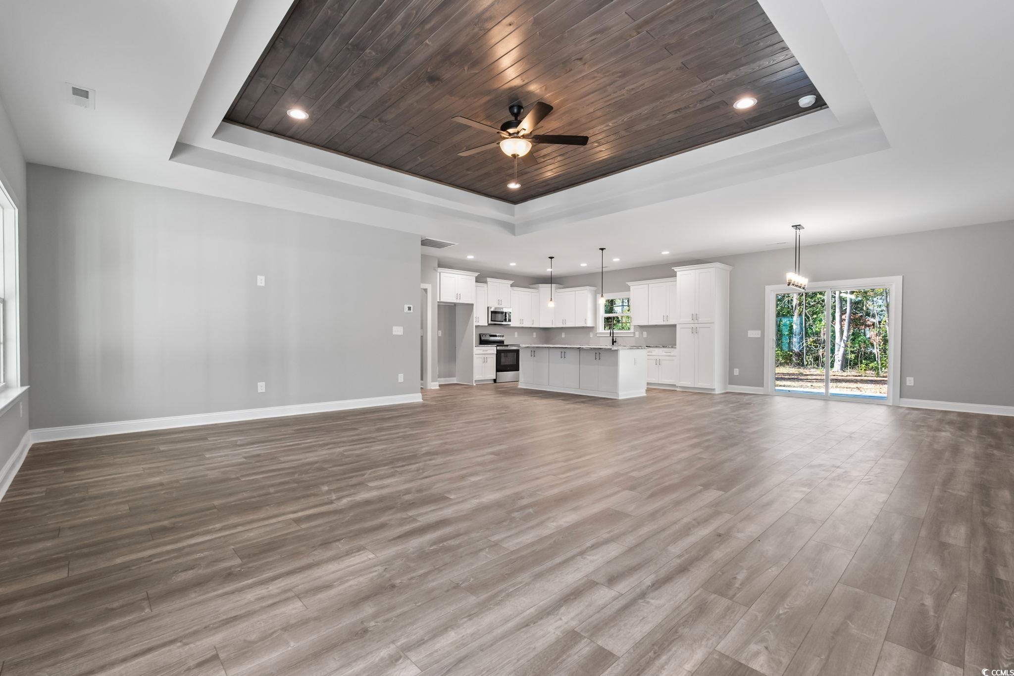 2122 Highway 9 Business Loris, SC 29569 - Photo 4 of 32 Unfurnished living room featuring wooden ceiling, a raised ceiling, light wood-style floors, ceiling fan, and recessed lighting
