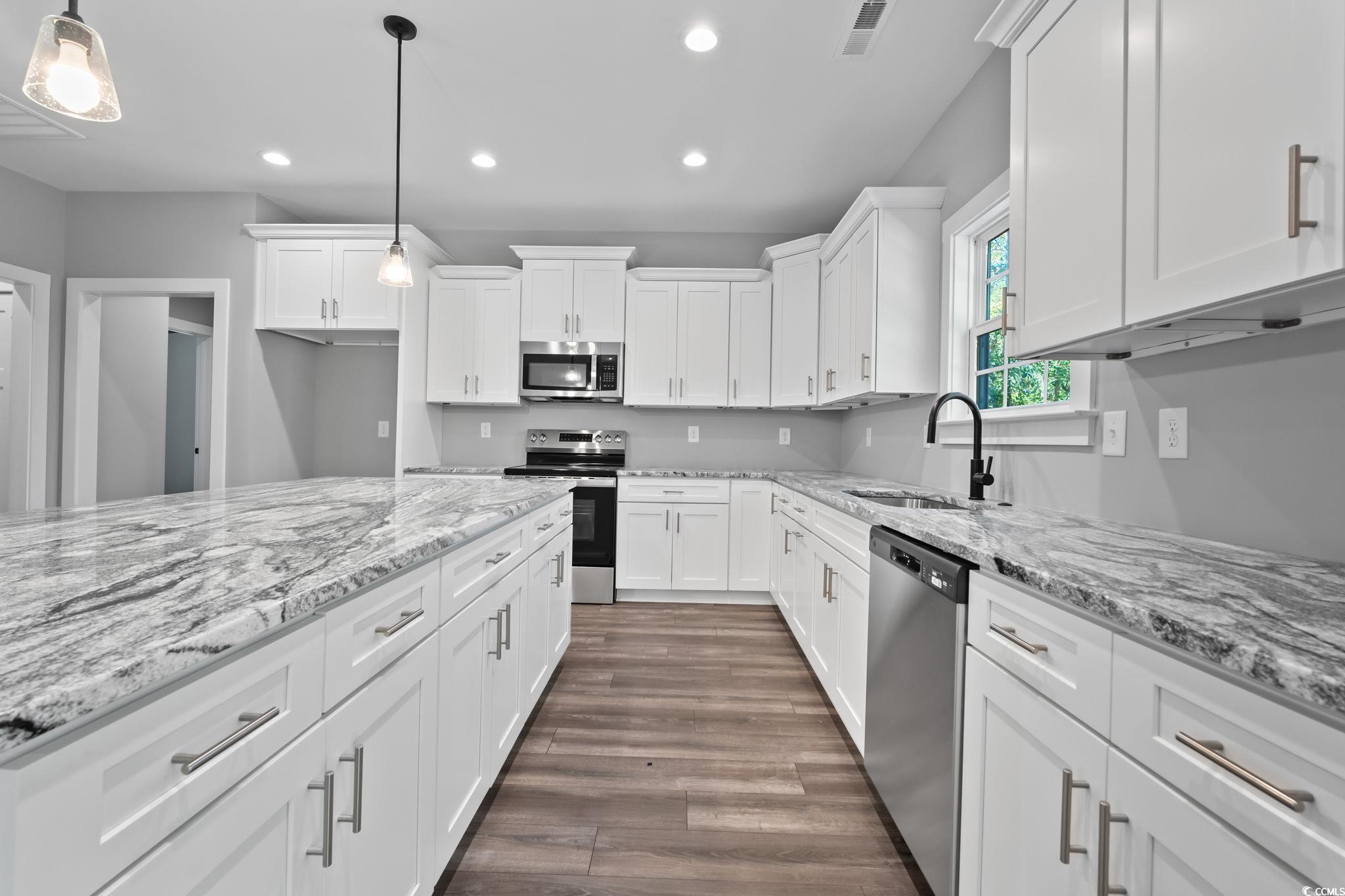 2122 Highway 9 Business Loris, SC 29569 - Photo 10 of 32 Kitchen with recessed lighting, stainless steel appliances, white cabinetry, and light stone countertops