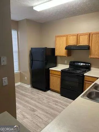 a view of a chairs in kitchen and a windows