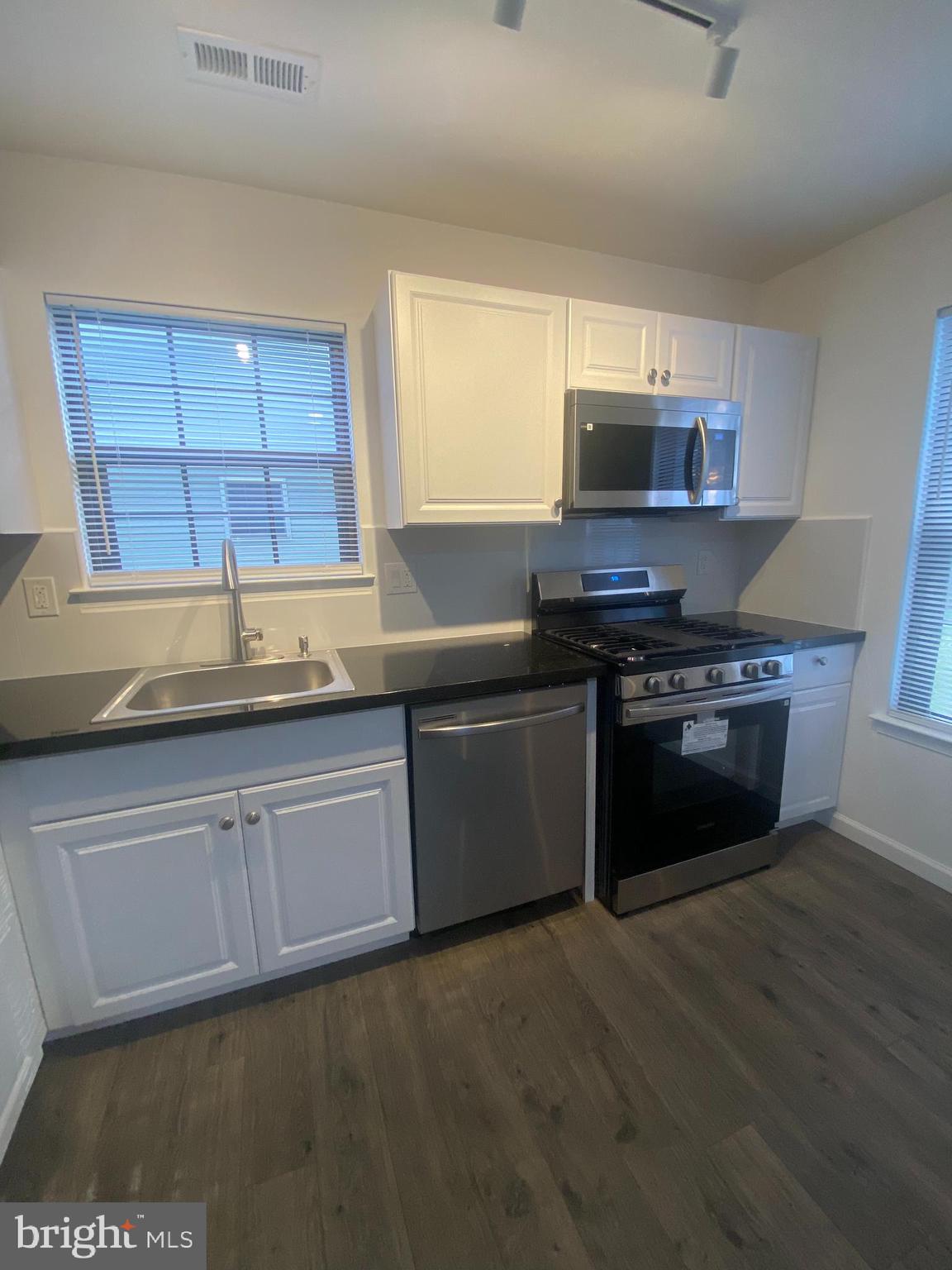 532 Cormorant Drive Voorhees, NJ 08043 - Photo 4 of 28 a kitchen with stainless steel appliances granite countertop a stove a sink and a microwave