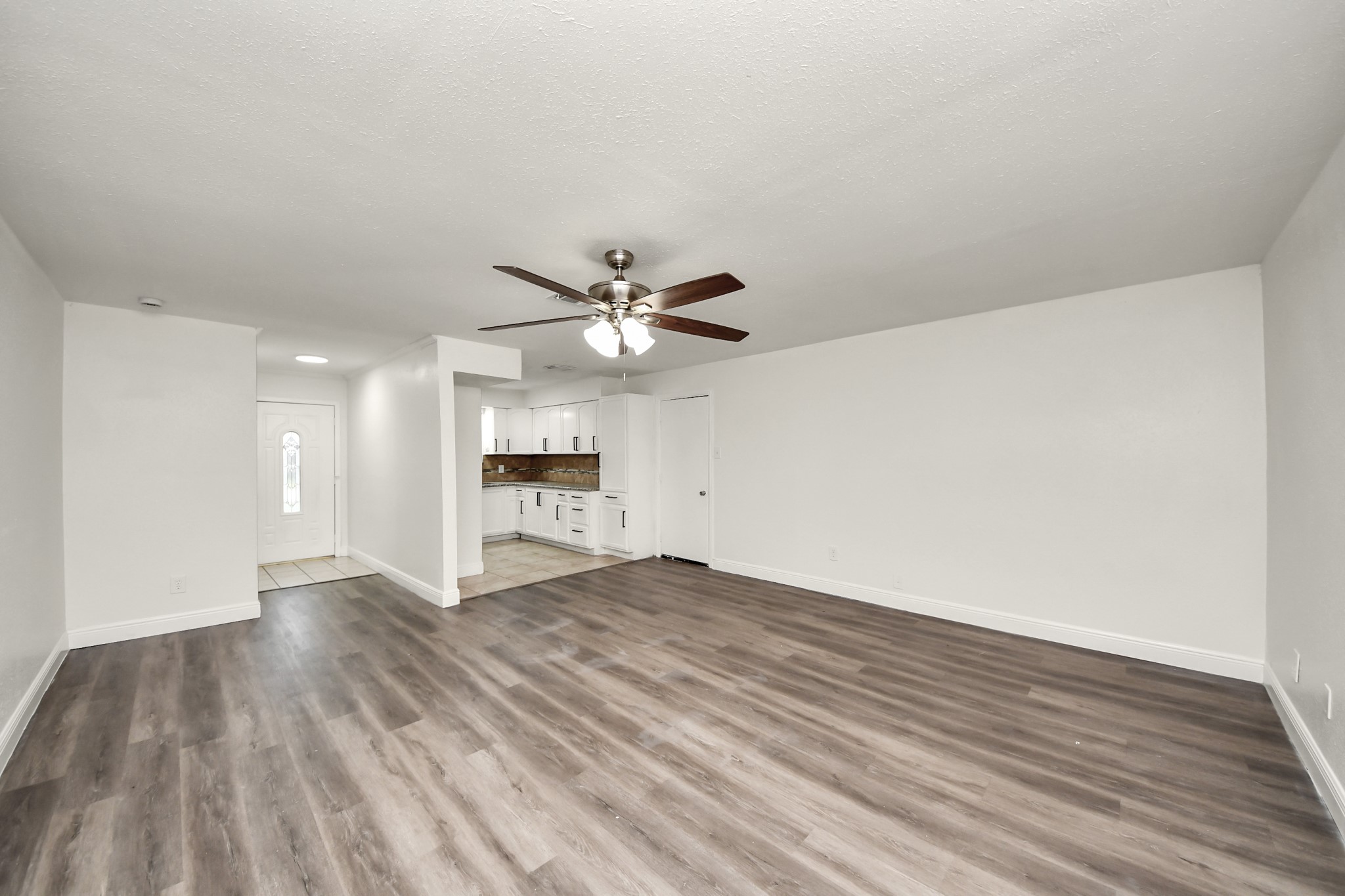 1139 Hartwick Road Houston, TX 77037 - Photo 19 of 38 a view of an empty room with wooden floor and a window
