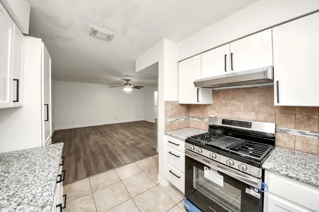 a kitchen with cabinets and appliances