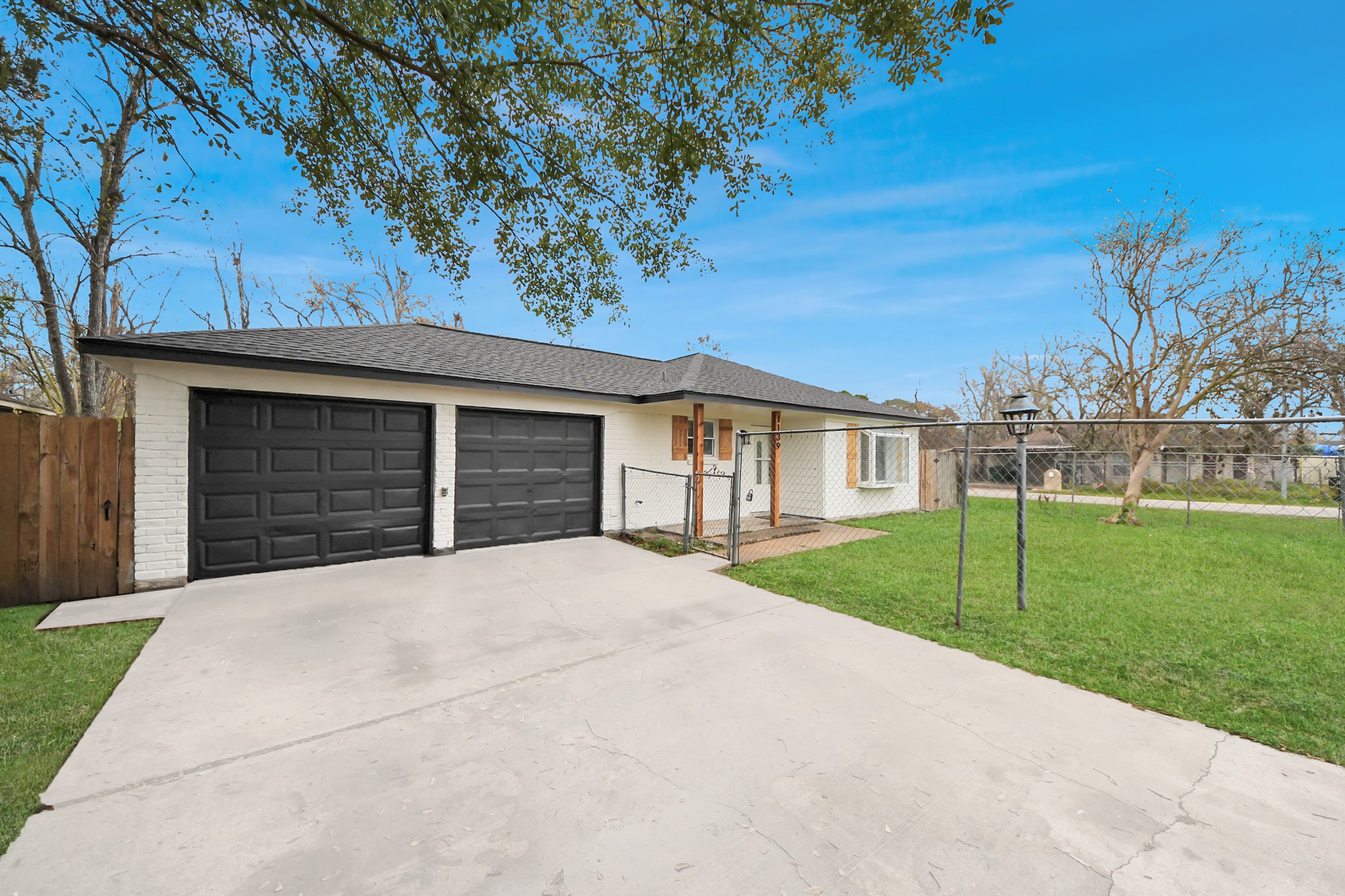 1139 Hartwick Road Houston, TX 77037 - Photo 3 of 38 a front view of a house with a yard and garage