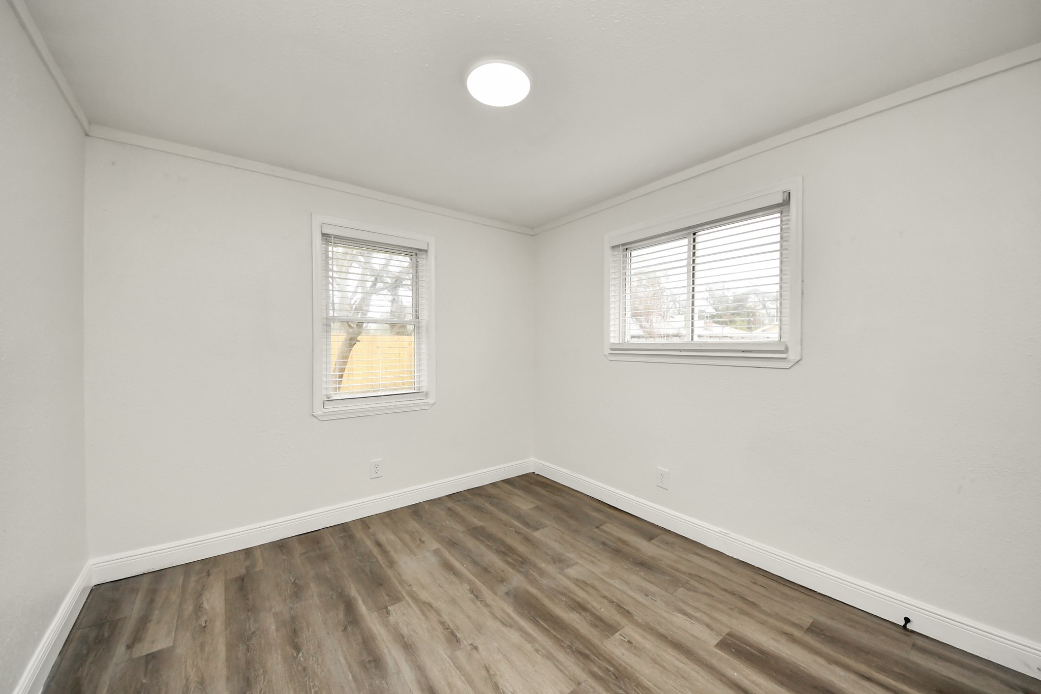 1139 Hartwick Road Houston, TX 77037 - Photo 31 of 38 an empty room with wooden floor and windows