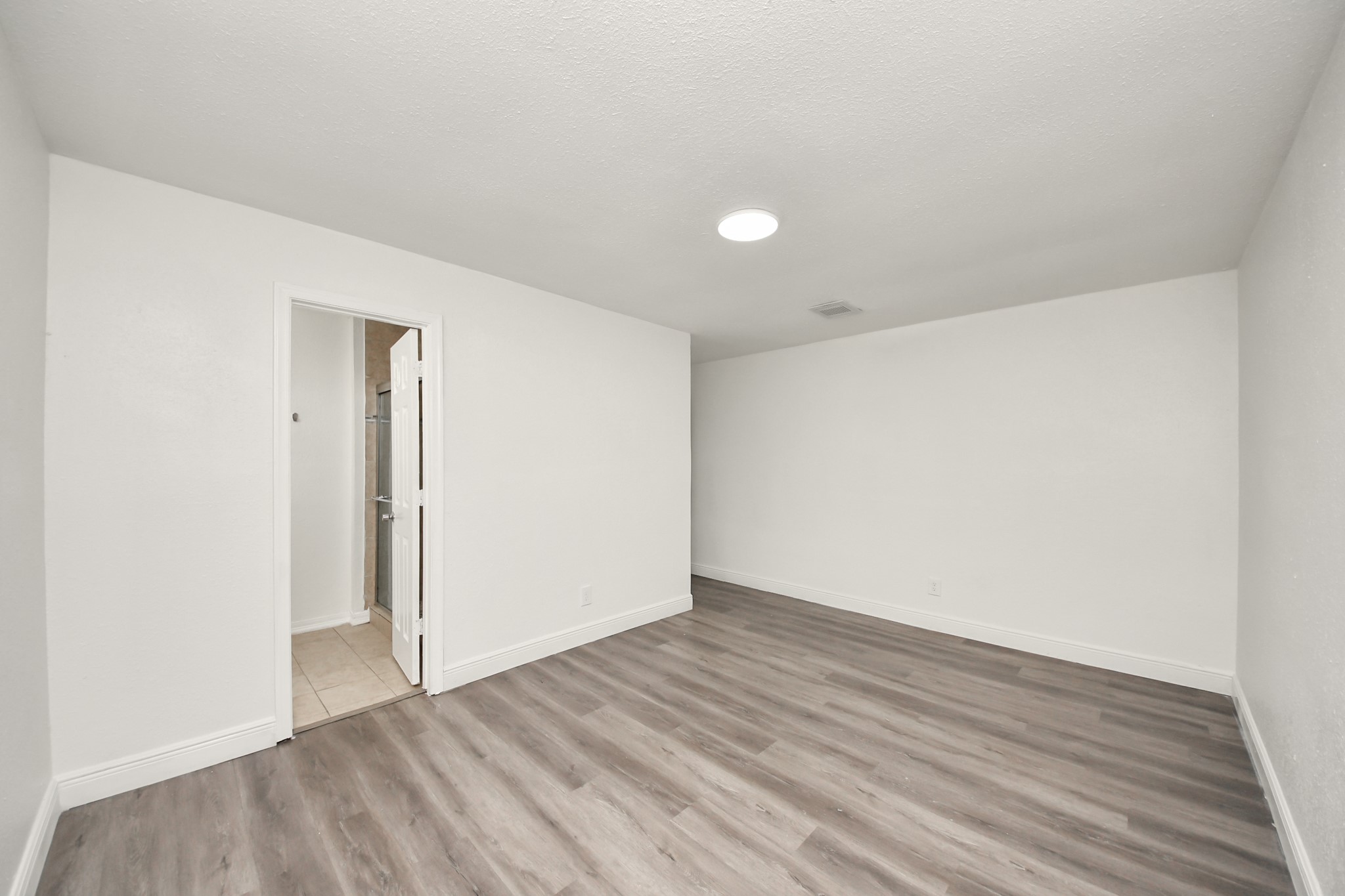 1139 Hartwick Road Houston, TX 77037 - Photo 35 of 38 a view of an empty room with wooden floor