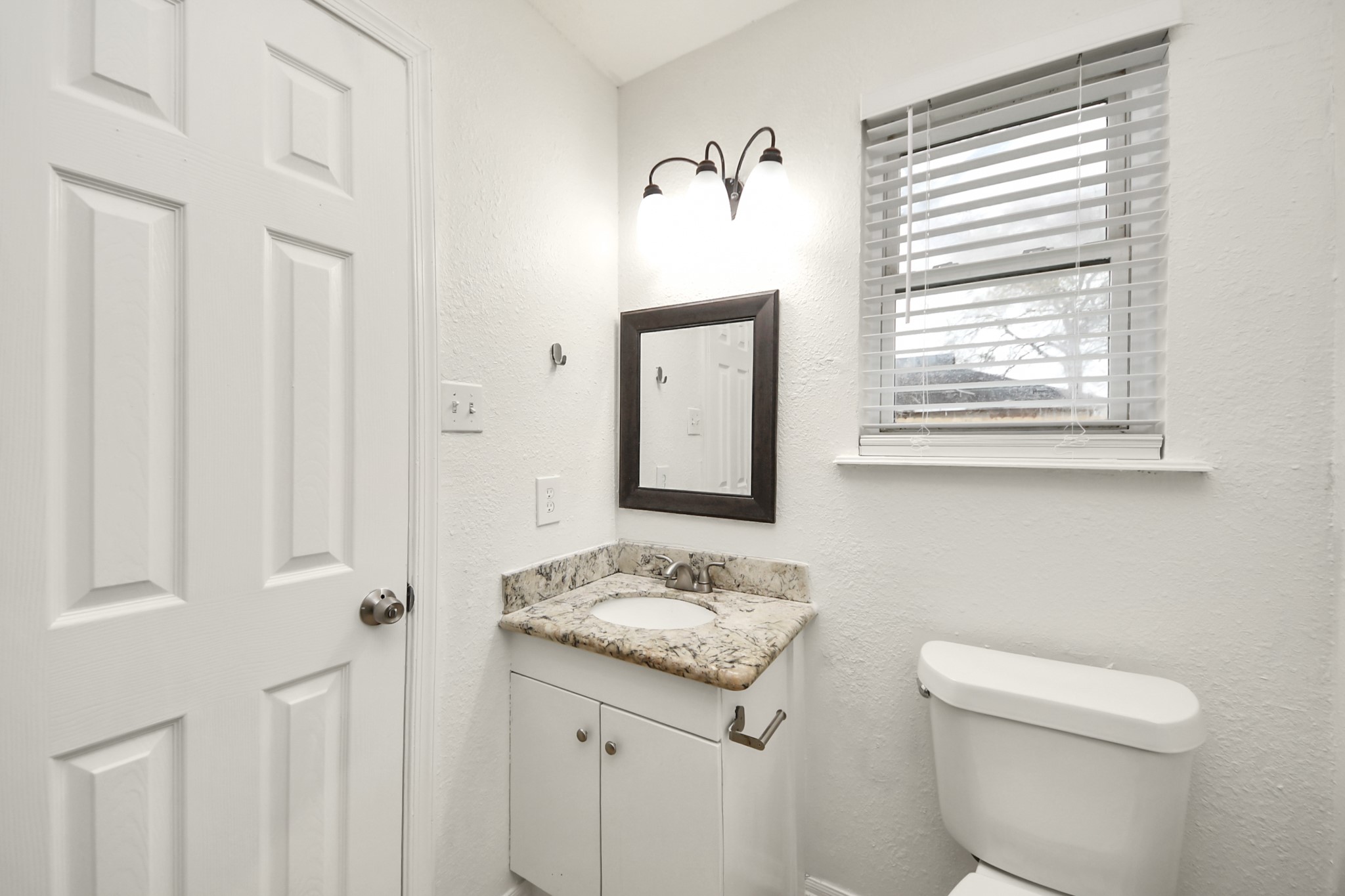 1139 Hartwick Road Houston, TX 77037 - Photo 38 of 38 a bathroom with a sink a toilet and a window