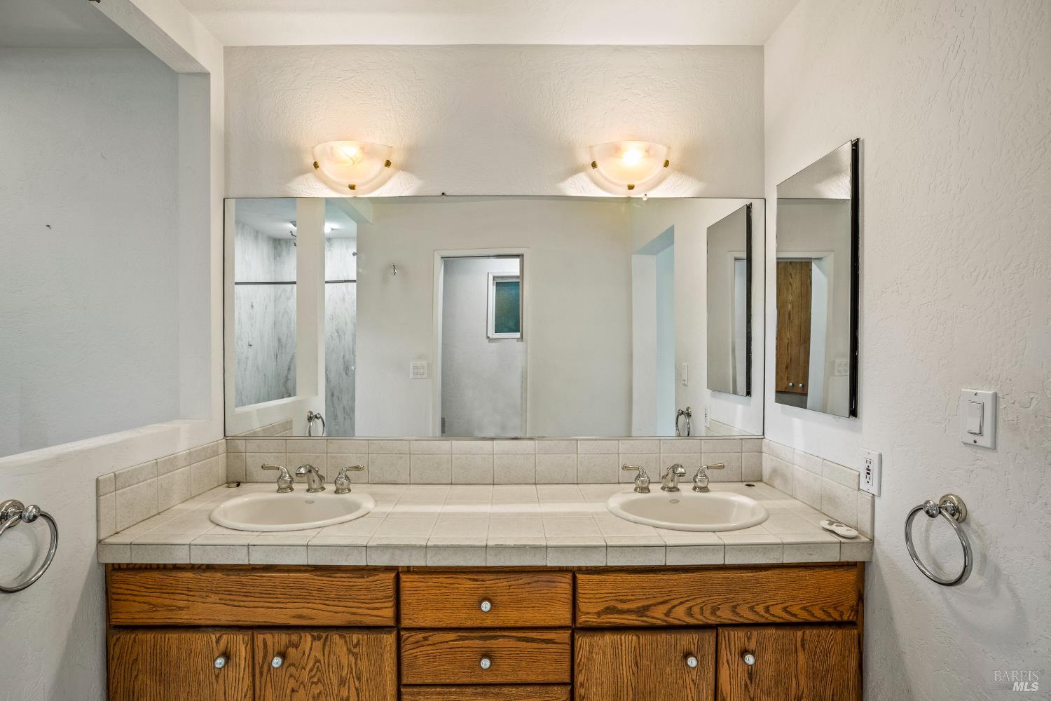 625-629 Hill Road Angwin, CA 94508 - Photo 17 of 64 a bathroom with a granite countertop sink and a mirror