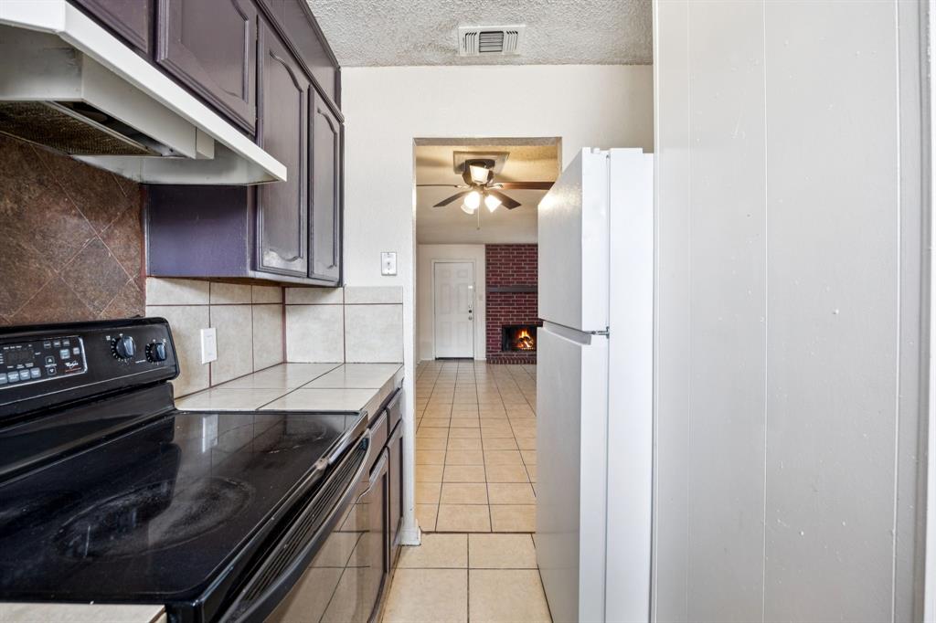 7504 Chapin Road Fort Worth, TX 76116 - Photo 11 of 30 a kitchen with a stove and a microwave