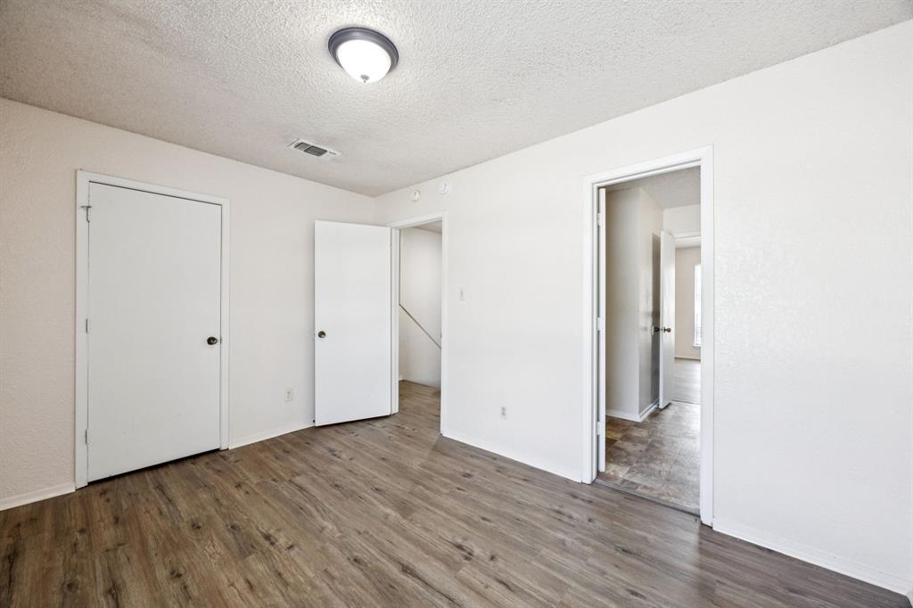 7504 Chapin Road Fort Worth, TX 76116 - Photo 16 of 30 a view of an empty room with wooden floor