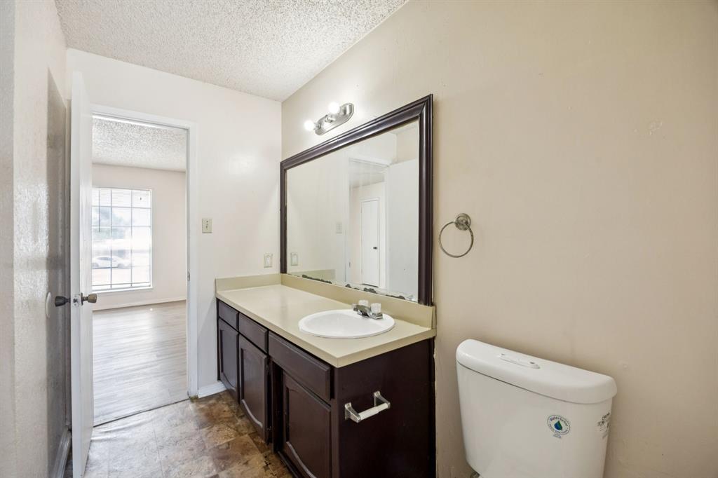 7504 Chapin Road Fort Worth, TX 76116 - Photo 17 of 30 a bathroom with a sink toilet and mirror