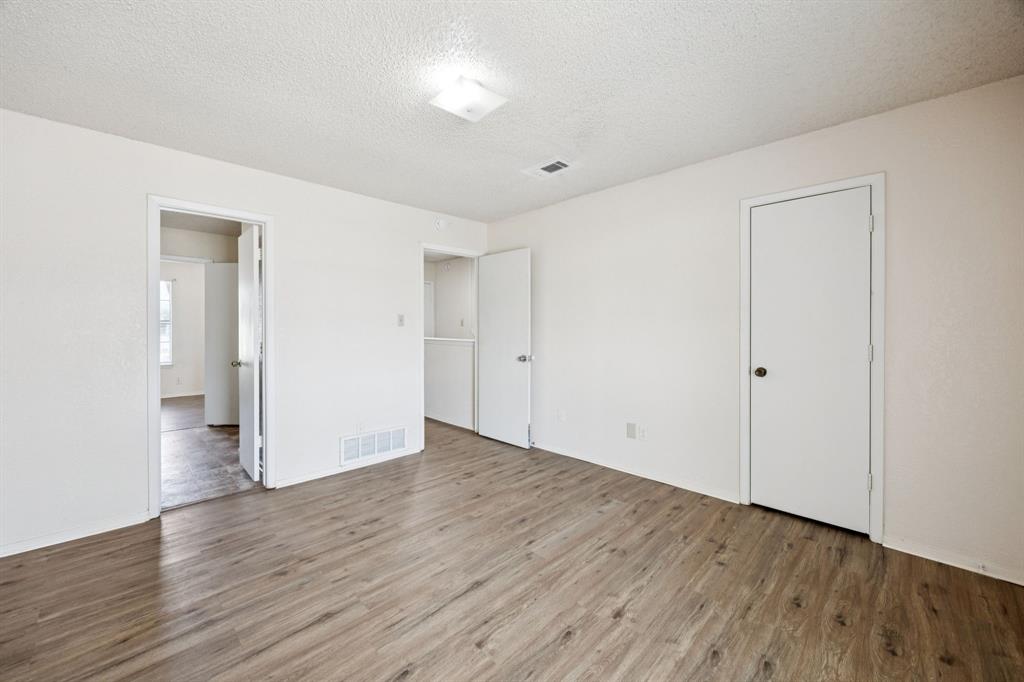 7504 Chapin Road Fort Worth, TX 76116 - Photo 20 of 30 a view of an empty room with wooden floor