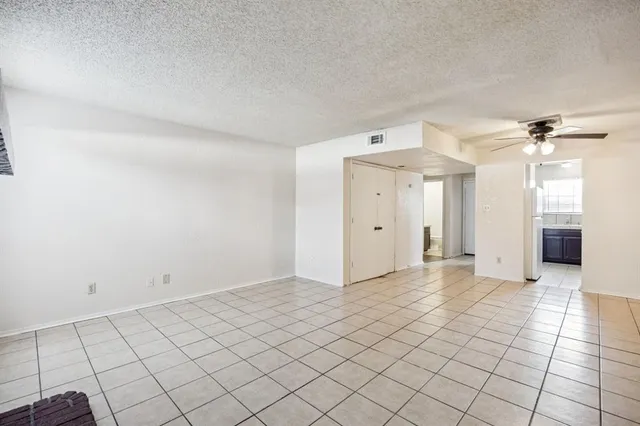 a view of a livingroom with an empty space and a window