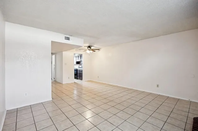 a view of a livingroom with an empty space and a window