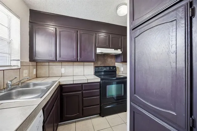 a kitchen with a sink and a refrigerator