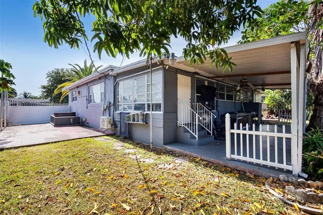 a view of a house with backyard and sitting area