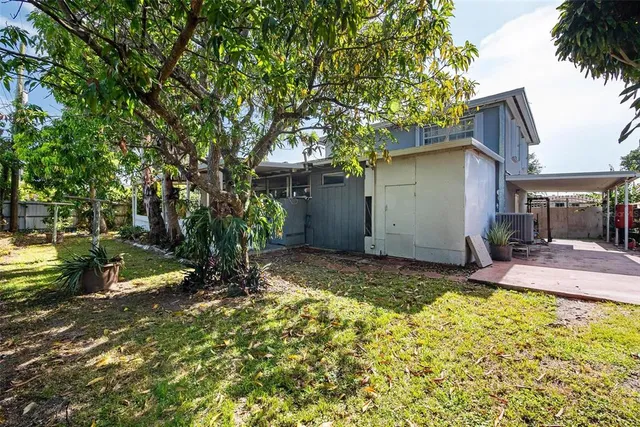 a view of a house with backyard and sitting area