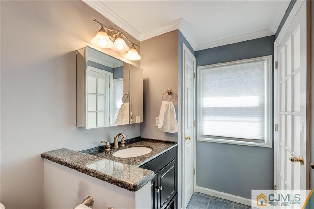 187 Oxford Road Colonia, NJ 07067 - Photo 14 of 25 a bathroom with a granite countertop sink and a mirror