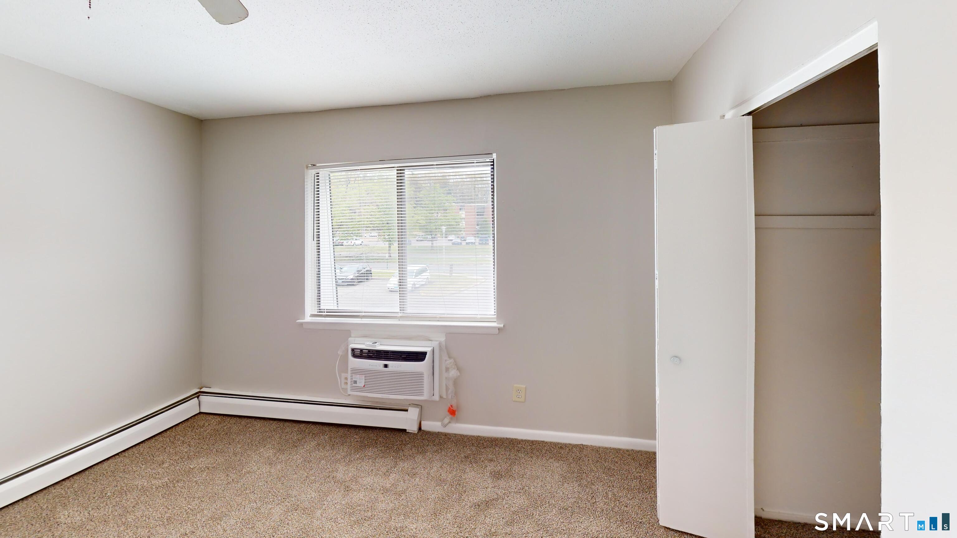 158 High Path Road, Unit 158 Windsor, CT 06095 - Photo 9 of 20 a view of an empty room with a window