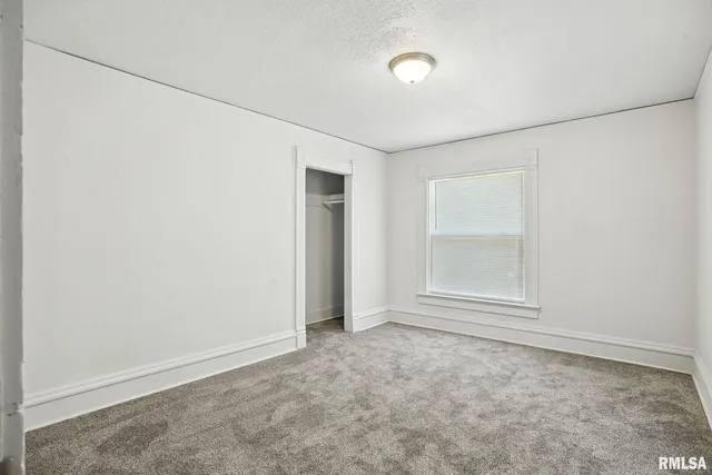 an empty room with a empty space and windows