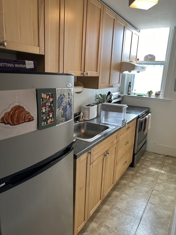 137 Peterborough Street, Unit 31 Boston, MA 02215 - Photo 1 of 14 a kitchen with stainless steel appliances a sink a stove and a refrigerator