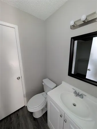 a white toilet sitting next to a bathroom sink