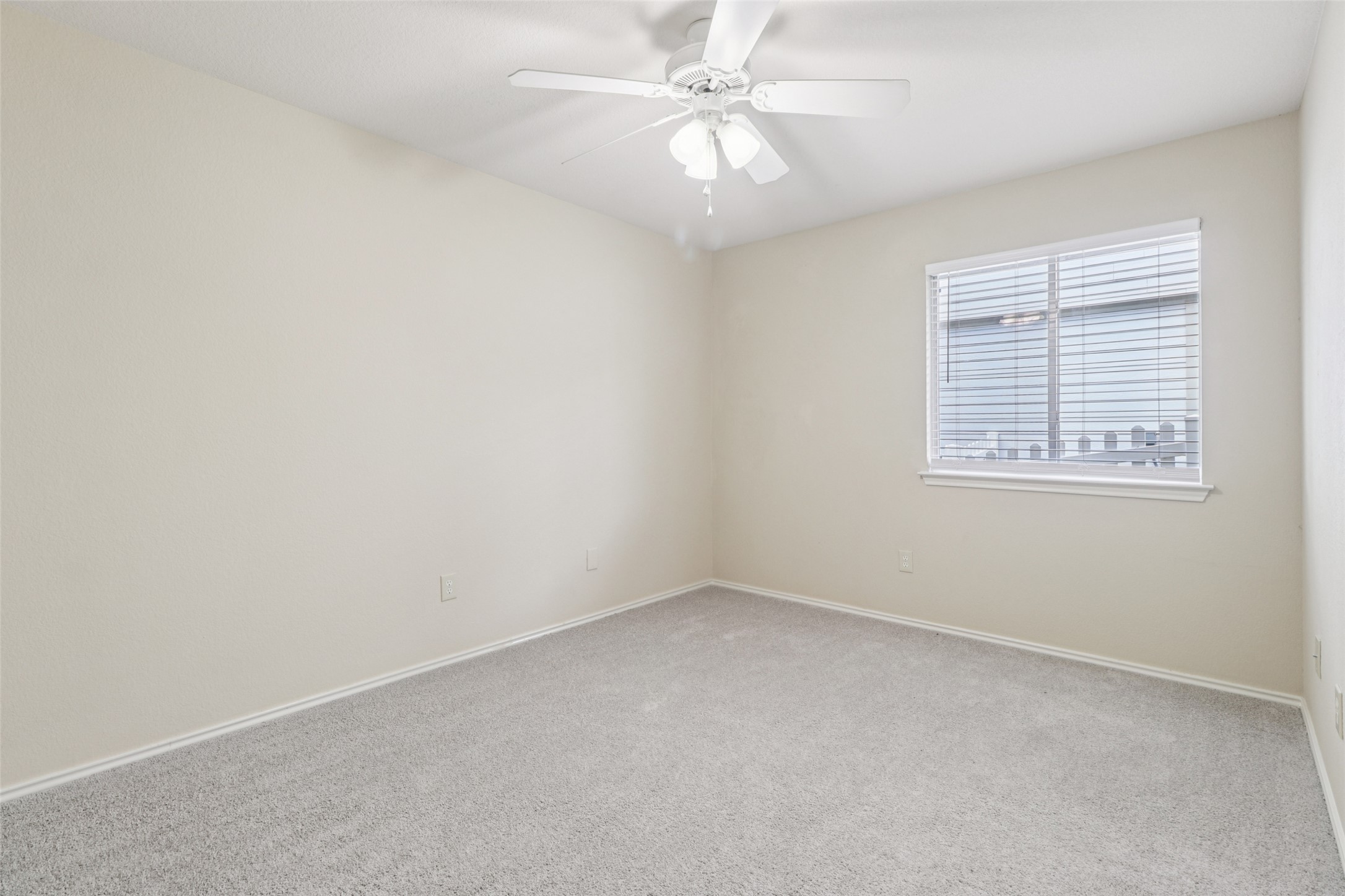 700 Scheel Road Kyle, TX 78640 - Photo 31 of 39 Bedroom featuring light-colored walls, carpeted flooring, a window with blinds, and a ceiling fan