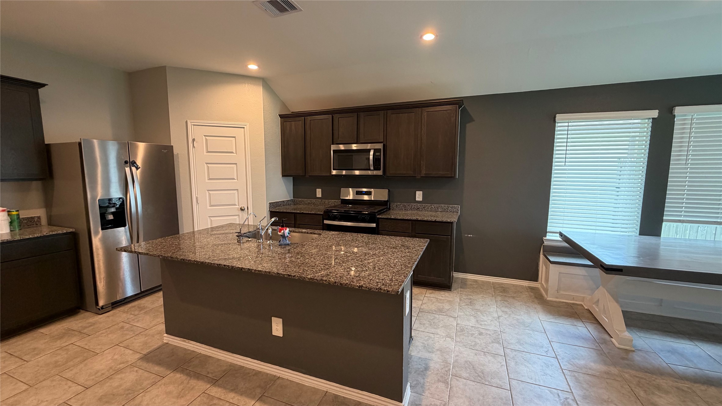 7518 Cynomys Court Rosharon, TX 77583 - Photo 7 of 21 a kitchen with kitchen island granite countertop a refrigerator and a sink