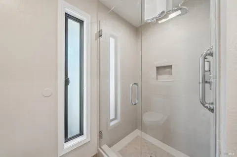 a bathroom with a shower toilet and sink