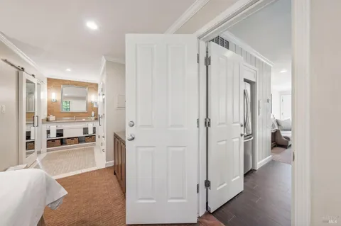 a view of a living room with a refrigerator and a table