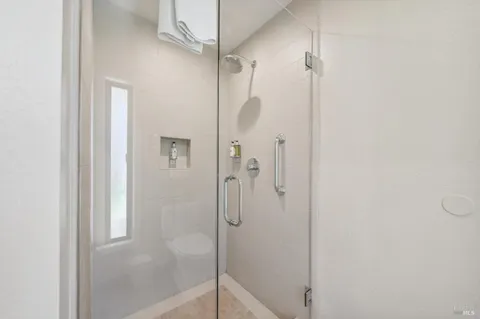 a bathroom with a glass shower door