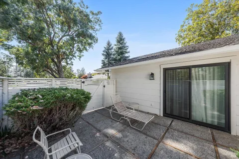a backyard of a house with lots of green space and glass windows