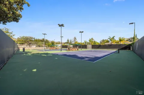 a view of a green field with sitting area