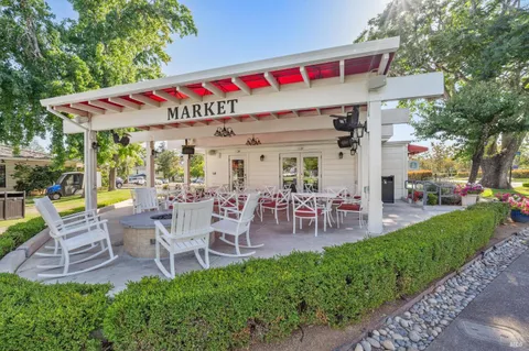 a view of a chairs and table in backyard of the house