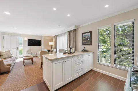 a living room with a large window and wooden floor
