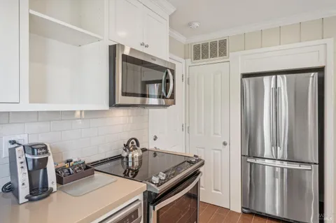 a kitchen with stainless steel appliances granite countertop a refrigerator sink and stove