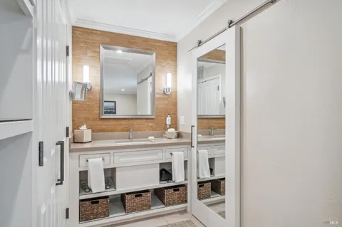 a bathroom with a double vanity sink and a mirror
