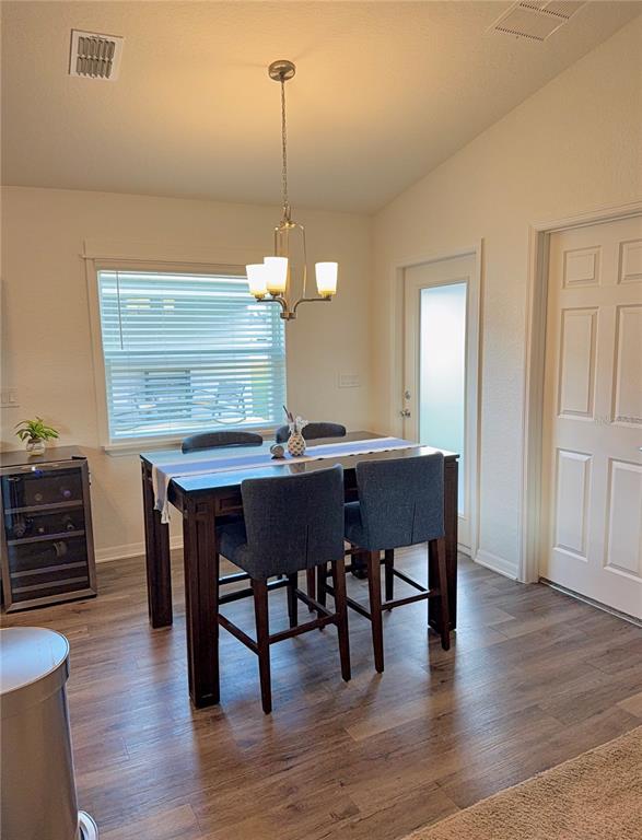 4448 Reding Way Lakeland, FL 33813 - Photo 11 of 26 a view of a dining room with furniture wooden floor and chandelier