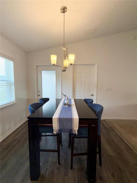 4448 Reding Way Lakeland, FL 33813 - Photo 12 of 26 a view of a dining room with furniture and wooden floor
