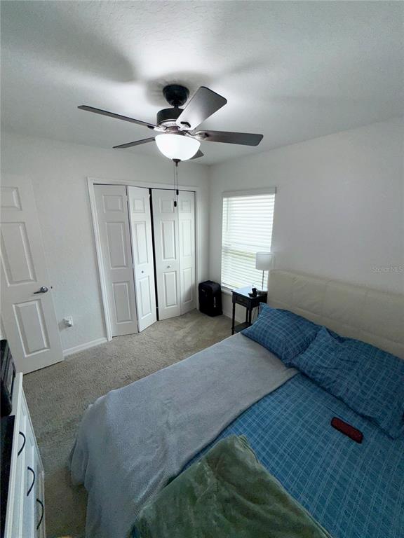 4448 Reding Way Lakeland, FL 33813 - Photo 16 of 26 a bedroom with a bed chandelier and a window