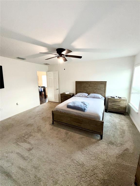4448 Reding Way Lakeland, FL 33813 - Photo 19 of 26 a bedroom with a bed and ceiling fan
