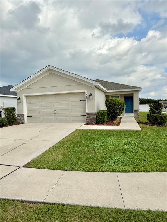 4448 Reding Way Lakeland, FL 33813 - Photo 2 of 26 a front view of a house with a garden and plants