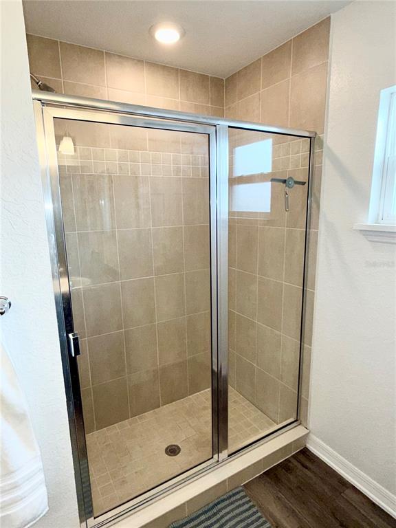 4448 Reding Way Lakeland, FL 33813 - Photo 21 of 26 a bathroom with a glass shower door
