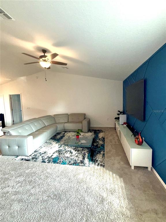 4448 Reding Way Lakeland, FL 33813 - Photo 4 of 26 a bed room with furniture and a flat screen tv