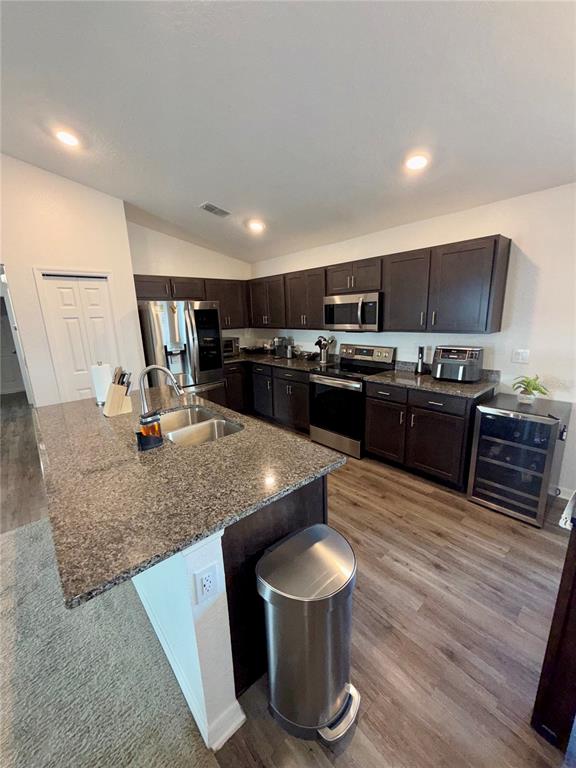 4448 Reding Way Lakeland, FL 33813 - Photo 7 of 26 a kitchen with stainless steel appliances granite countertop a sink a stove top oven a counter space and cabinets