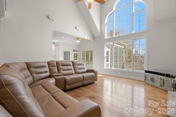 a living room with furniture a fireplace and kitchen view